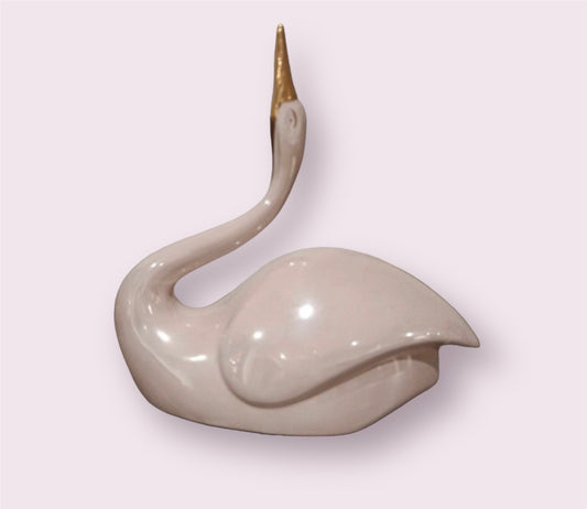 Antique pink swan with golden beak