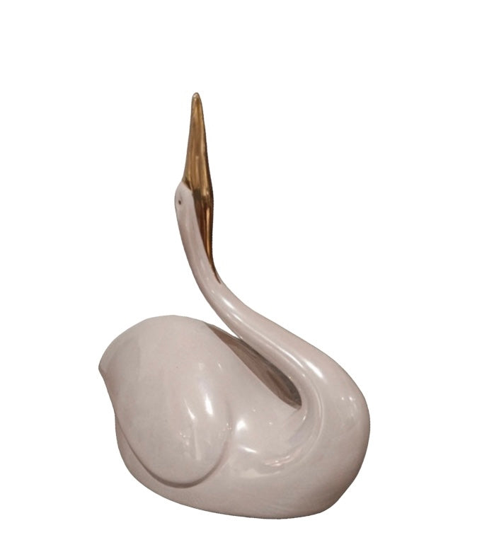 Antique pink swan with golden beak